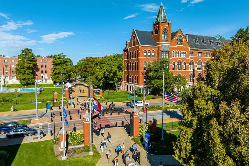 An aerial view of SLU and Grand Boulevard. Students cross the street at the crosswalk.