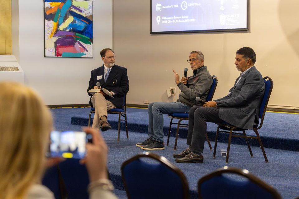 Bob Chapman Speaker Series 2025 three men seated speaking on a stage in front of a crowd