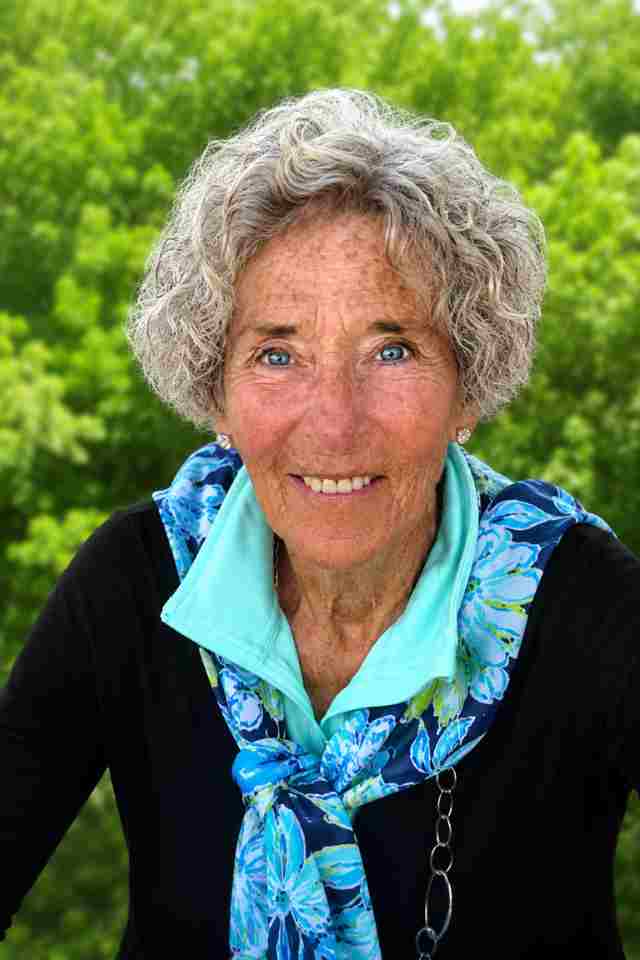 A photo showing Linda Vogt's head and shoulders. She is wearing a scarf and is in a natural setting.