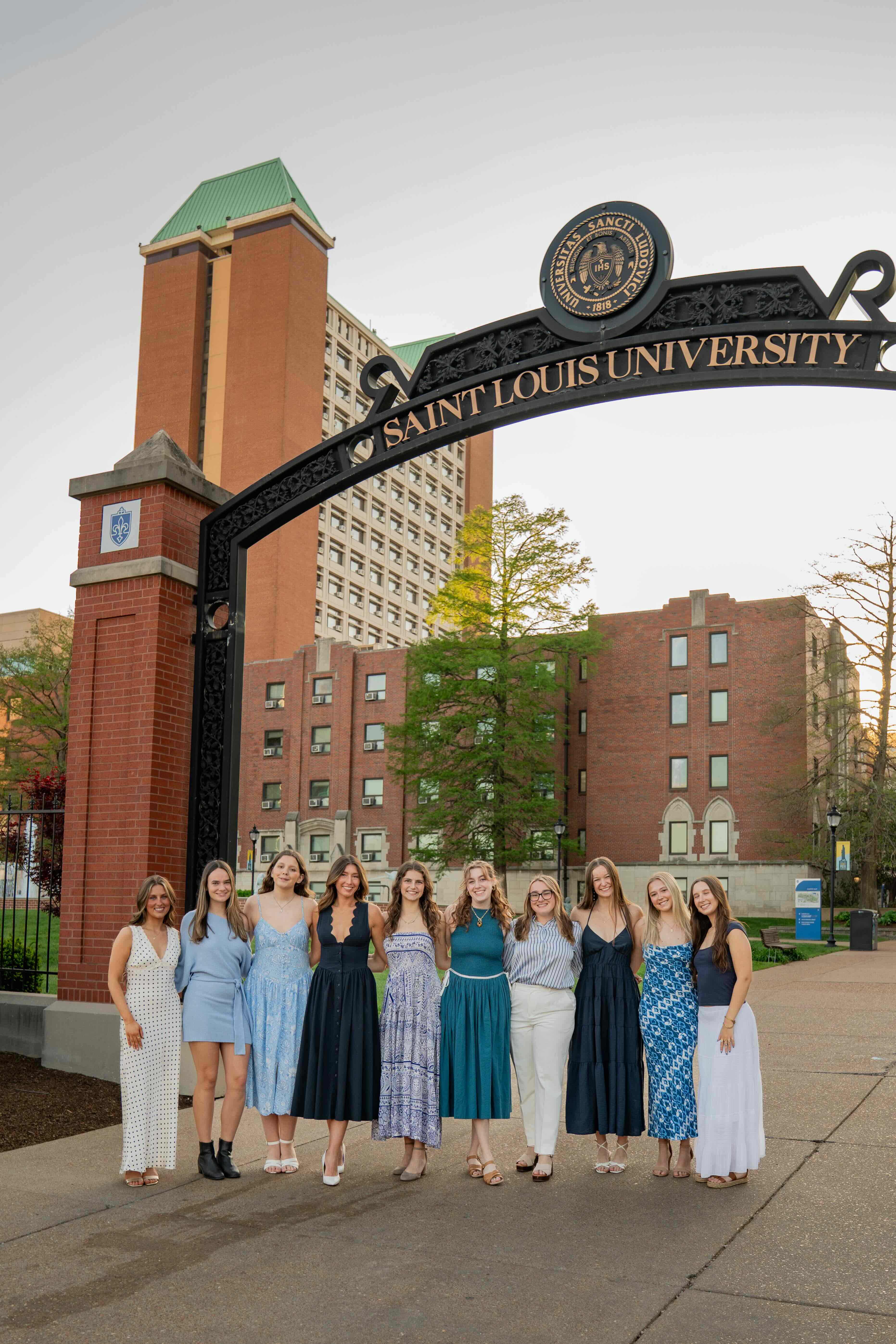 Panhellenic executive board members posing under the Saint Louis University archway