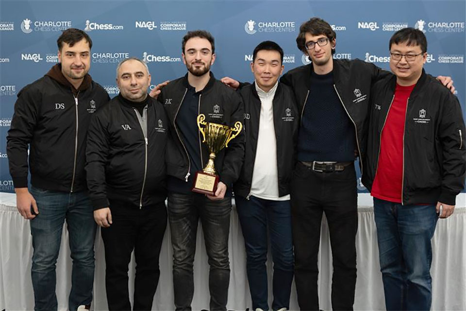 men pose for a photo with a trophy