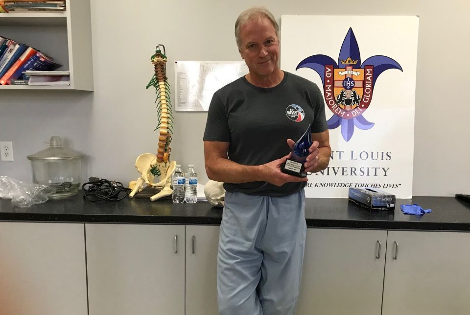 A man holding a trophy