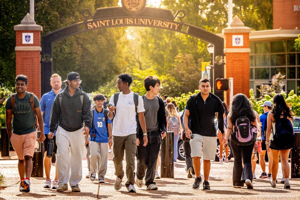 Student Resources A group of SLU students walk under the pedestrian archway on SLU's campus.